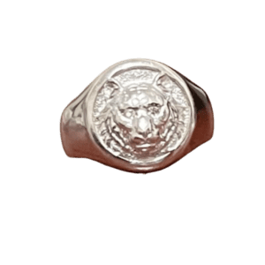 A silver ring with a face on it